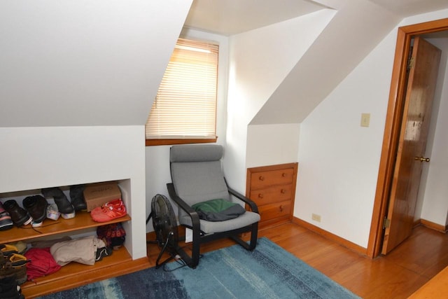 sitting room with vaulted ceiling and hardwood / wood-style floors