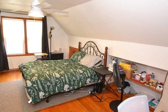 bedroom featuring hardwood / wood-style flooring, ceiling fan, and vaulted ceiling