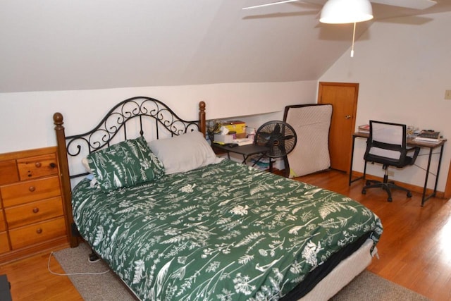 bedroom with vaulted ceiling, ceiling fan, and hardwood / wood-style floors