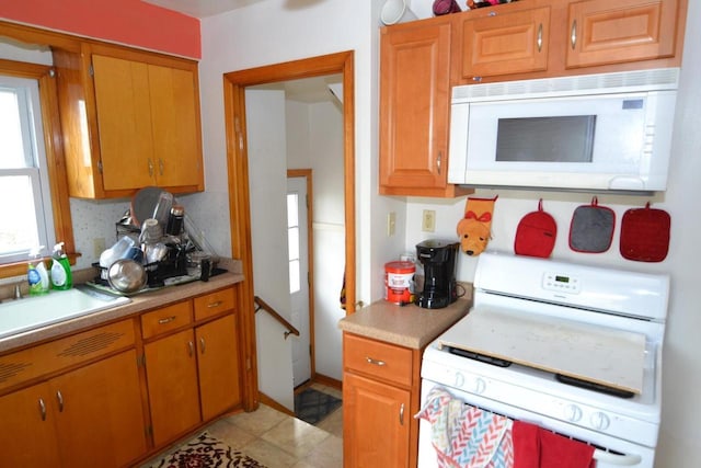 kitchen featuring white appliances and sink