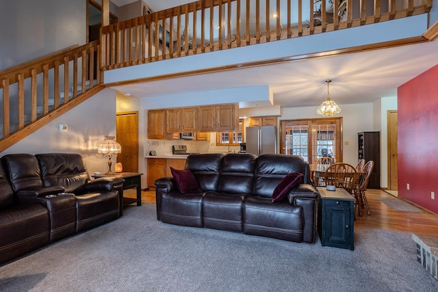 living room featuring an inviting chandelier and a towering ceiling