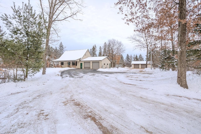 snowy yard with a garage