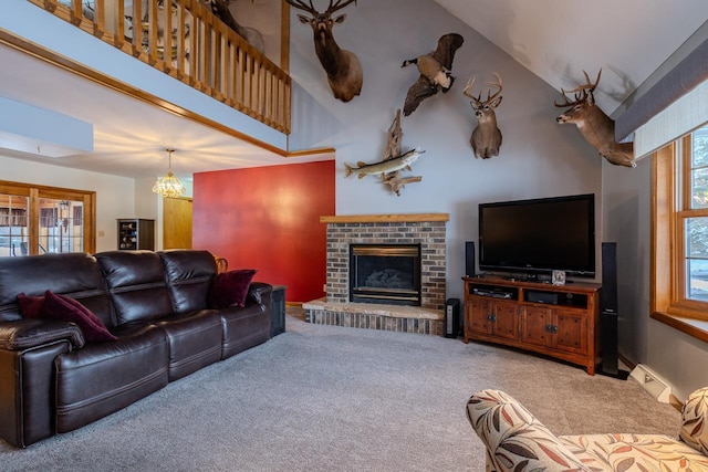 carpeted living room featuring a towering ceiling and a fireplace