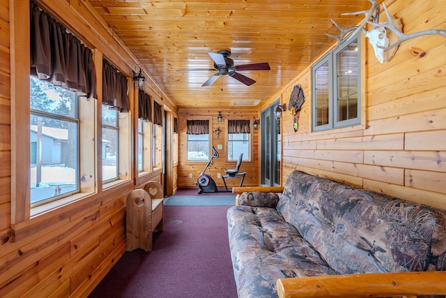 unfurnished sunroom with wood ceiling and ceiling fan