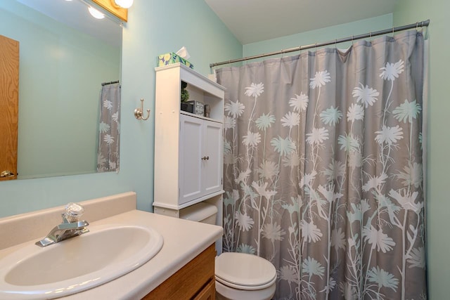 bathroom featuring vanity, curtained shower, and toilet