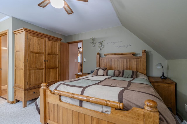 carpeted bedroom with ceiling fan and vaulted ceiling