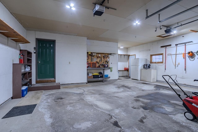 garage with a garage door opener, white fridge, refrigerator, and a workshop area