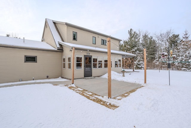 view of snow covered rear of property