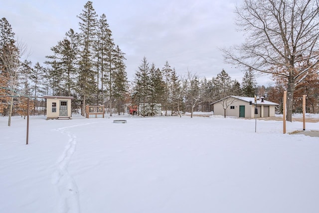 yard covered in snow with an outdoor structure