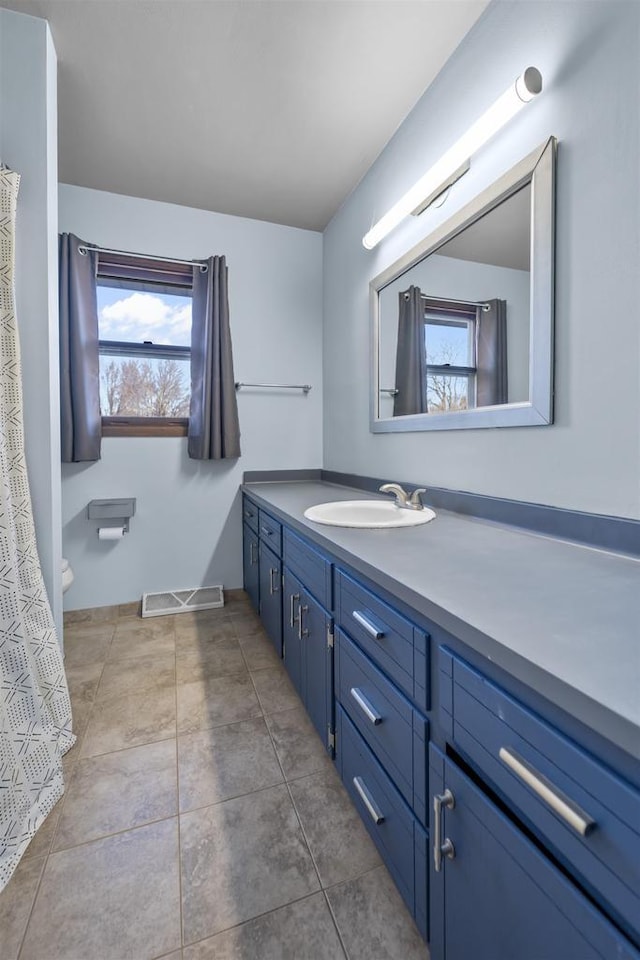 bathroom featuring tile patterned flooring and vanity