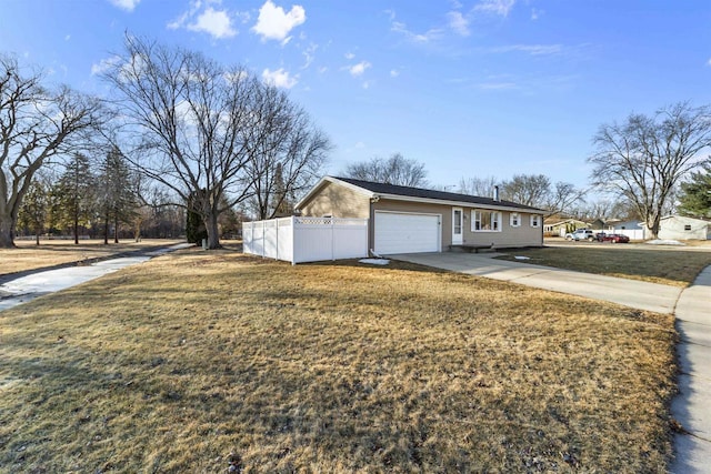 view of side of home featuring a garage and a lawn