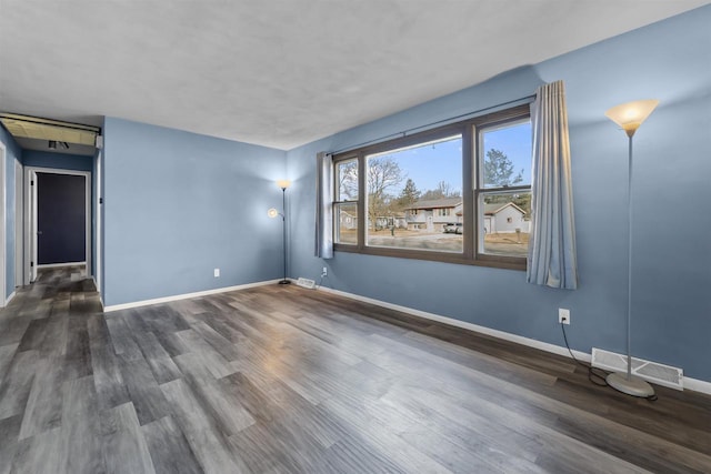 spare room featuring dark hardwood / wood-style flooring