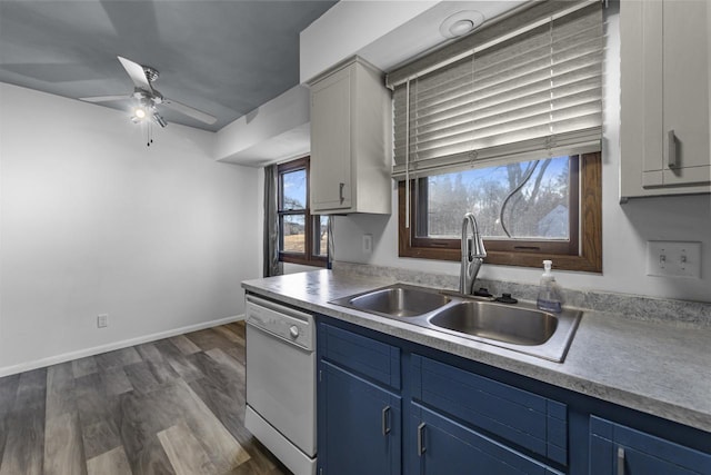 kitchen with blue cabinetry, sink, dark hardwood / wood-style flooring, dishwasher, and ceiling fan