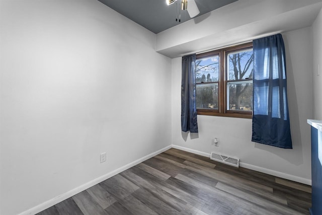 unfurnished room with ceiling fan and dark hardwood / wood-style flooring