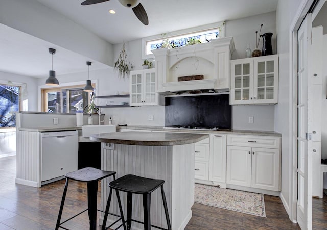 kitchen featuring white cabinetry, hanging light fixtures, white appliances, and a kitchen island