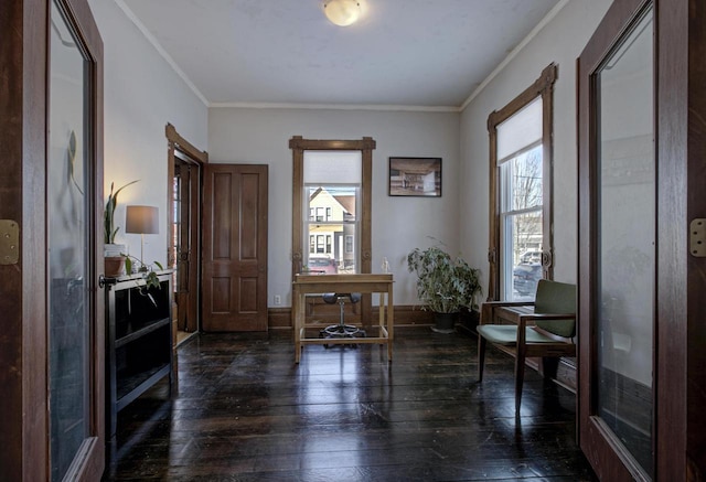 sitting room with crown molding, a healthy amount of sunlight, and dark hardwood / wood-style flooring