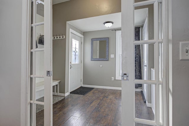 foyer entrance featuring dark hardwood / wood-style floors and french doors