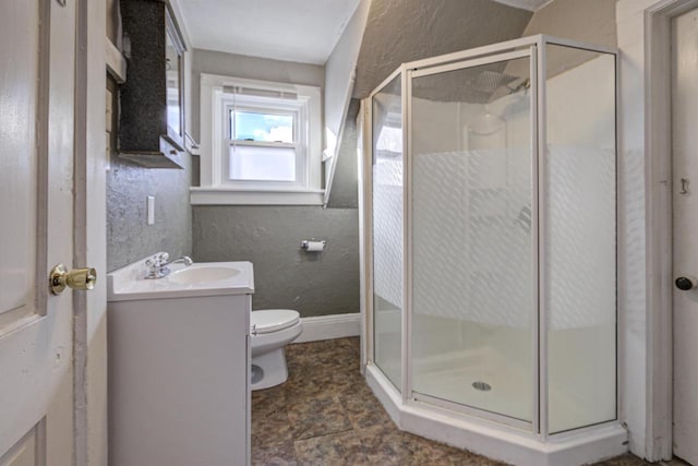 bathroom featuring walk in shower, vanity, and toilet