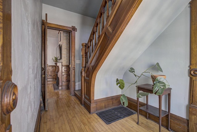 stairs featuring hardwood / wood-style floors