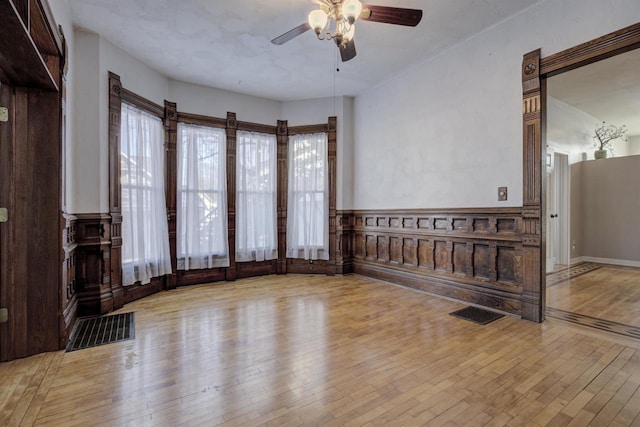 unfurnished living room featuring ceiling fan and light hardwood / wood-style floors