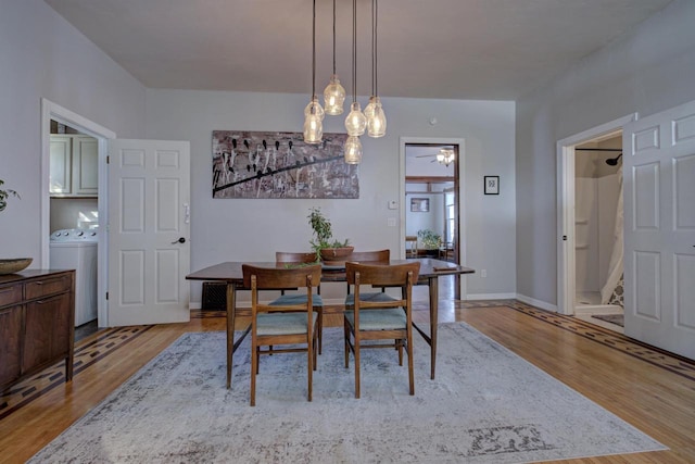 dining area featuring washer / clothes dryer and light wood-type flooring