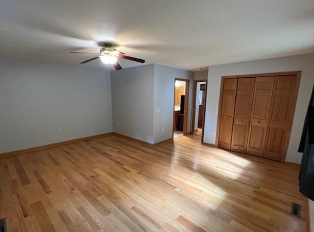 unfurnished bedroom with ceiling fan, ensuite bathroom, light hardwood / wood-style floors, and a closet