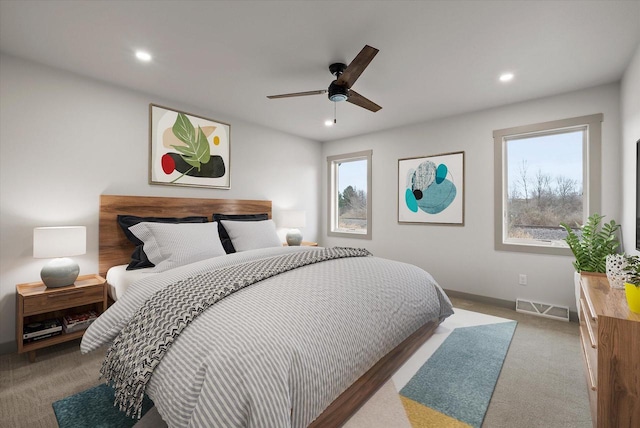 bedroom featuring light colored carpet and ceiling fan