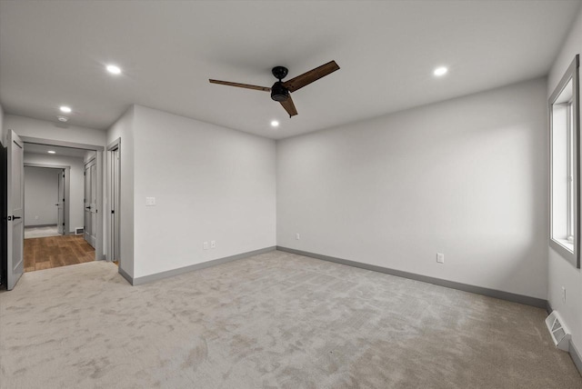 carpeted spare room with ceiling fan