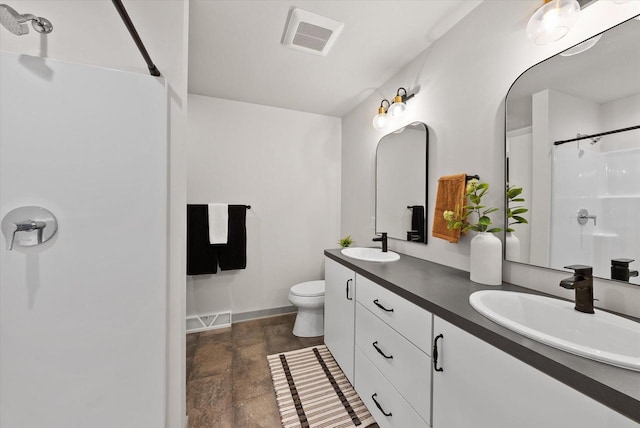 bathroom featuring vanity, a shower, and toilet