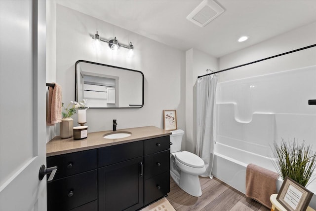 full bathroom featuring shower / bathtub combination with curtain, vanity, hardwood / wood-style flooring, and toilet