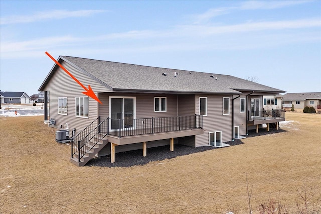 back of property with cooling unit, a lawn, and a deck