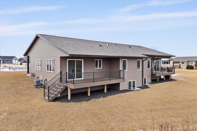 back of house with a wooden deck, a yard, and central AC