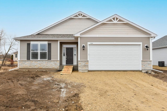 craftsman-style house with central AC and a garage