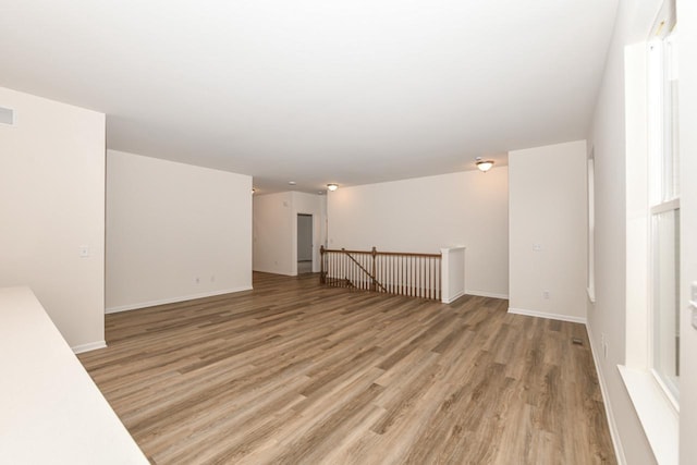 unfurnished room with light wood-type flooring