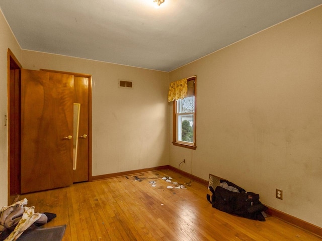 spare room with hardwood / wood-style floors