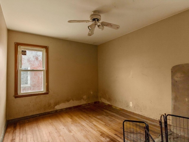 empty room with ceiling fan and light wood-type flooring