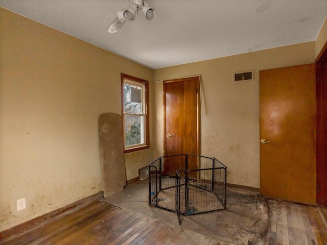 empty room featuring wood-type flooring