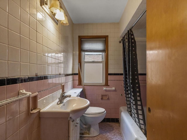 full bathroom with toilet, shower / tub combo, tile walls, vanity, and radiator