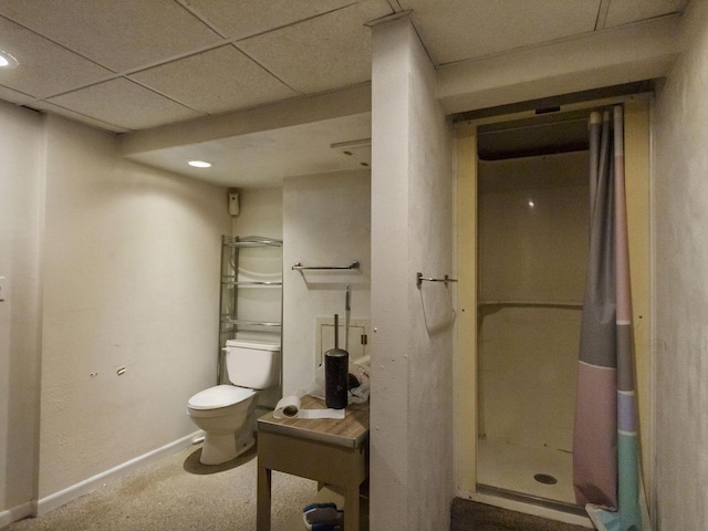 bathroom featuring a paneled ceiling and toilet