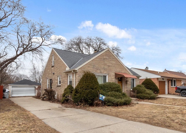 view of front of home with a garage and an outbuilding