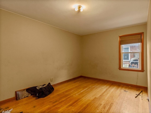 empty room with light hardwood / wood-style flooring