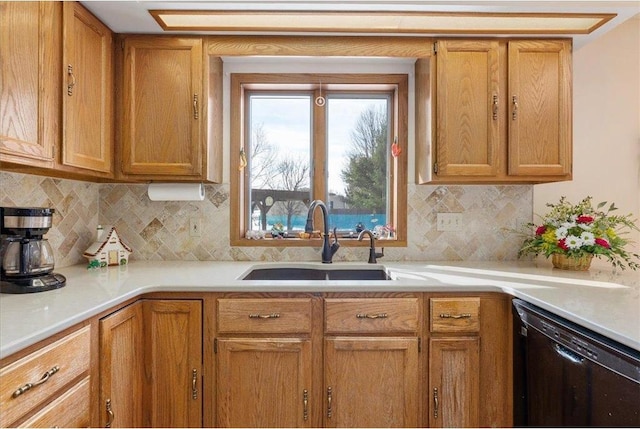 kitchen featuring dishwasher, sink, and backsplash