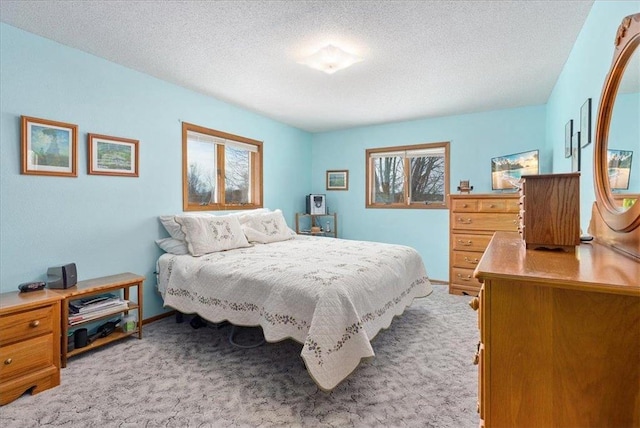 carpeted bedroom with a textured ceiling