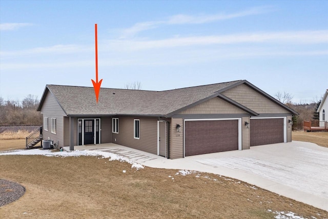 ranch-style house featuring central AC and a garage