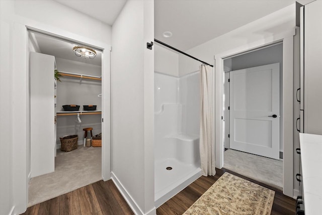 bathroom with hardwood / wood-style floors and a shower with curtain