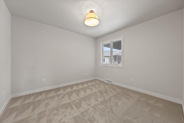 unfurnished room with light carpet