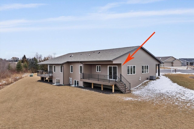 back of property featuring a wooden deck and cooling unit