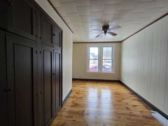 unfurnished bedroom featuring ornamental molding and light hardwood / wood-style flooring