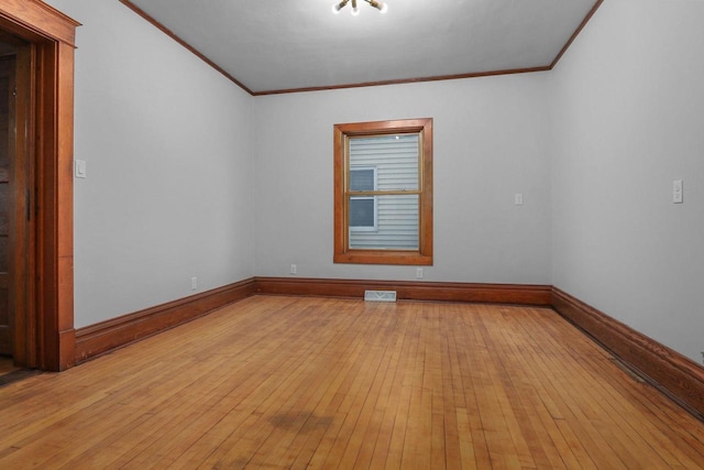 spare room with crown molding and light hardwood / wood-style flooring