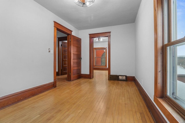 unfurnished room with light wood-type flooring